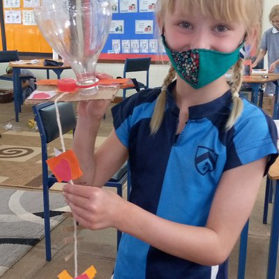 Islay's bird feeder made from plastic, string and coloured card.jpg